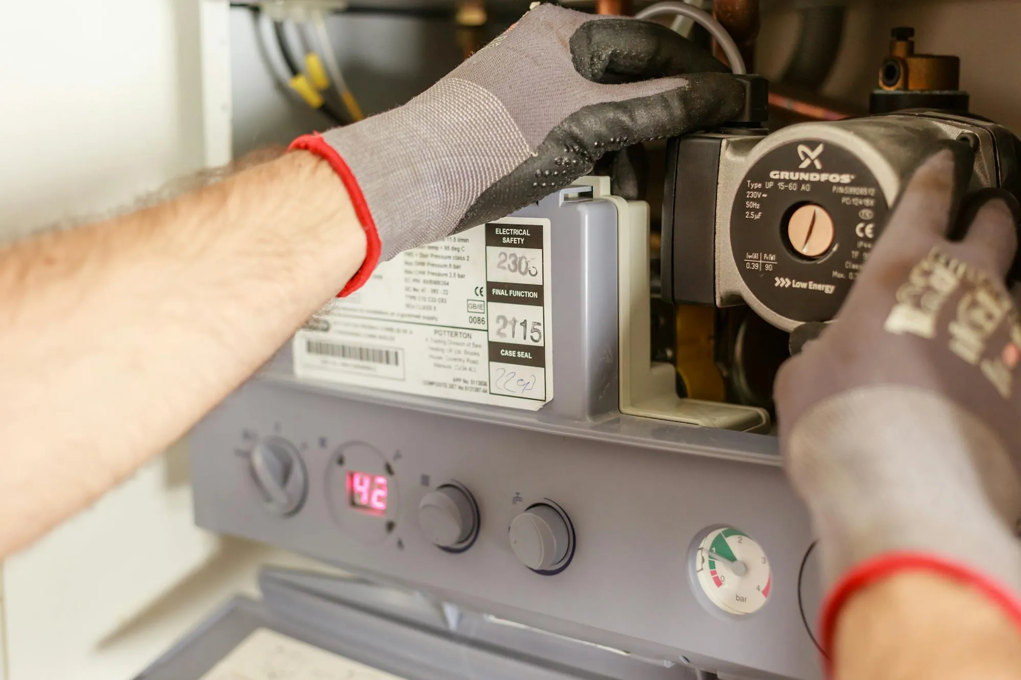 Gas Safe engineer working inside a wall-mounted gas boiler in Leeds