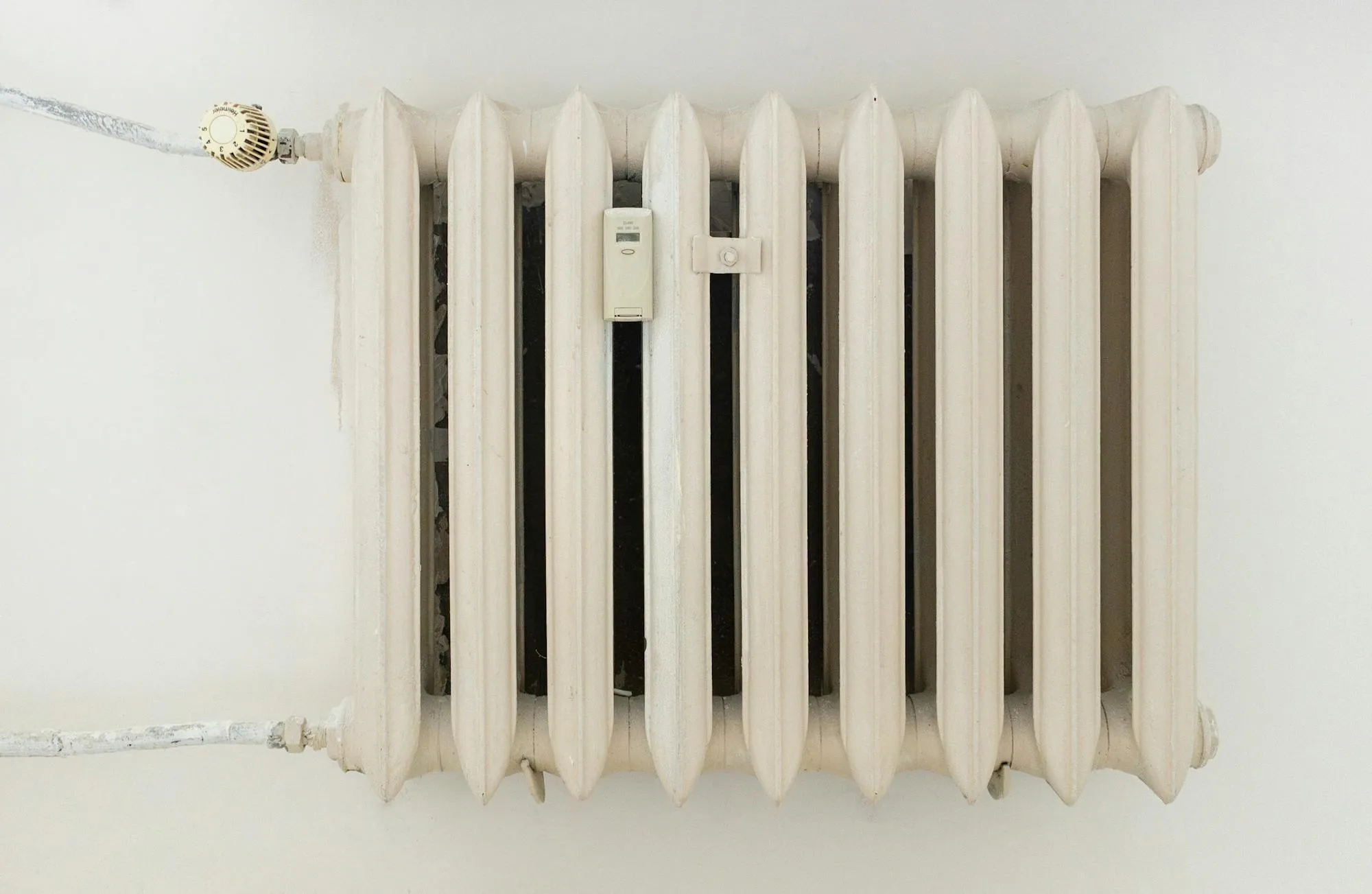Older cast iron radiator with thermostatic valve in a Leeds rental flat